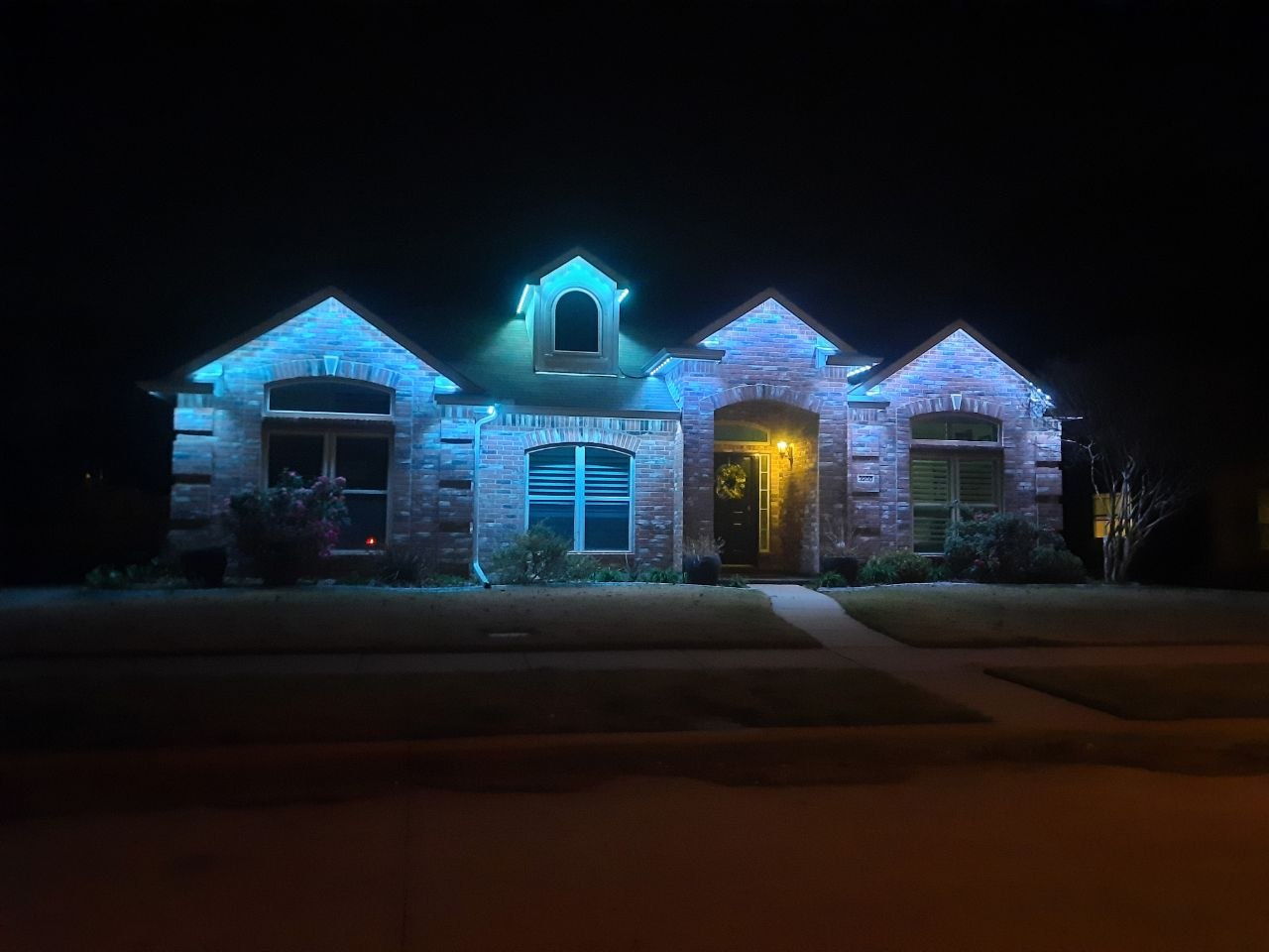 Blue architectural exterior lighting on a North Dallas home